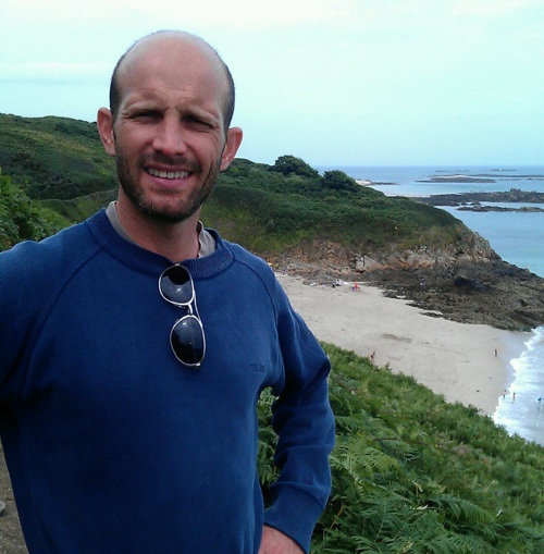 Willmott standing near the beach